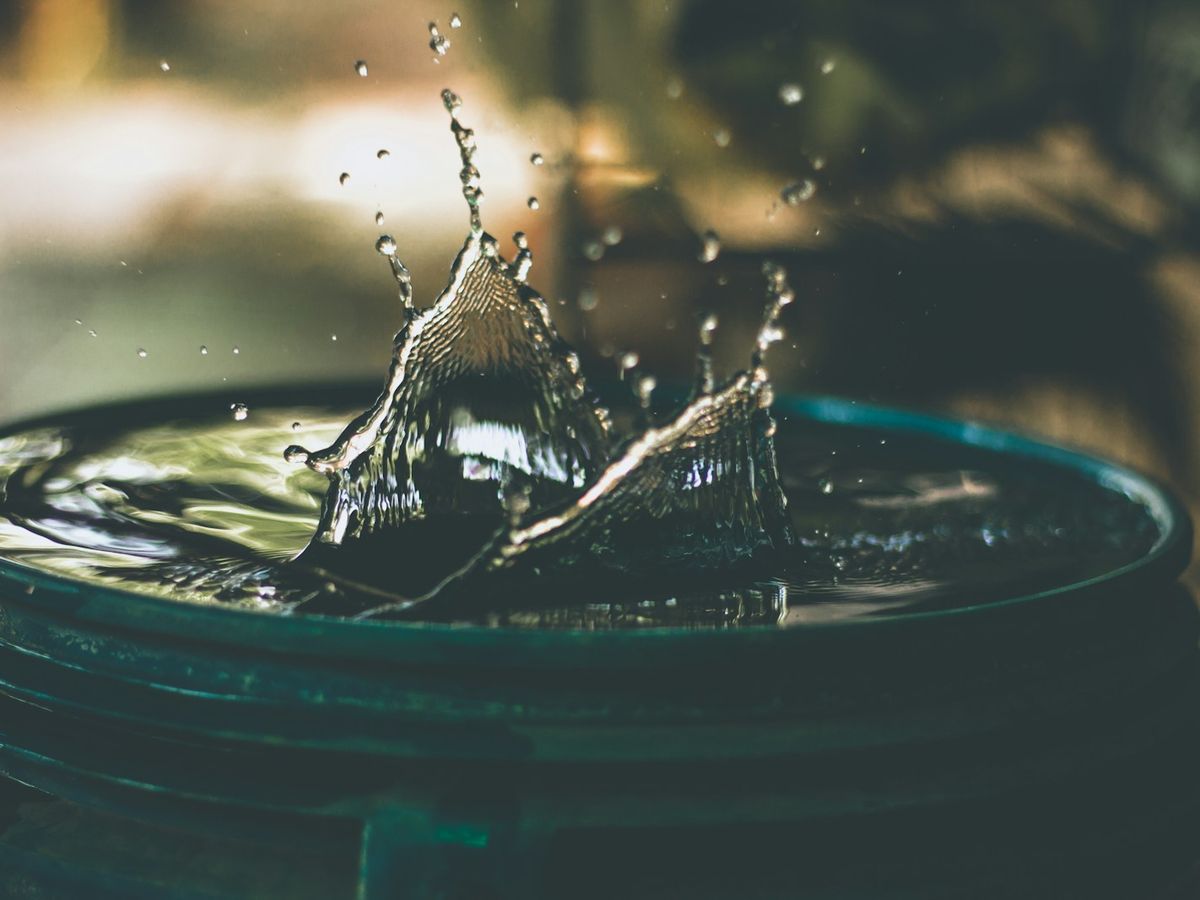 Goutte d’eau qui tombe dans un seau sous une fuite